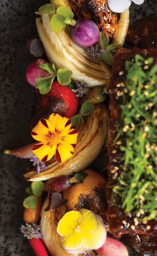 Colorful fruit and flowers on a plate